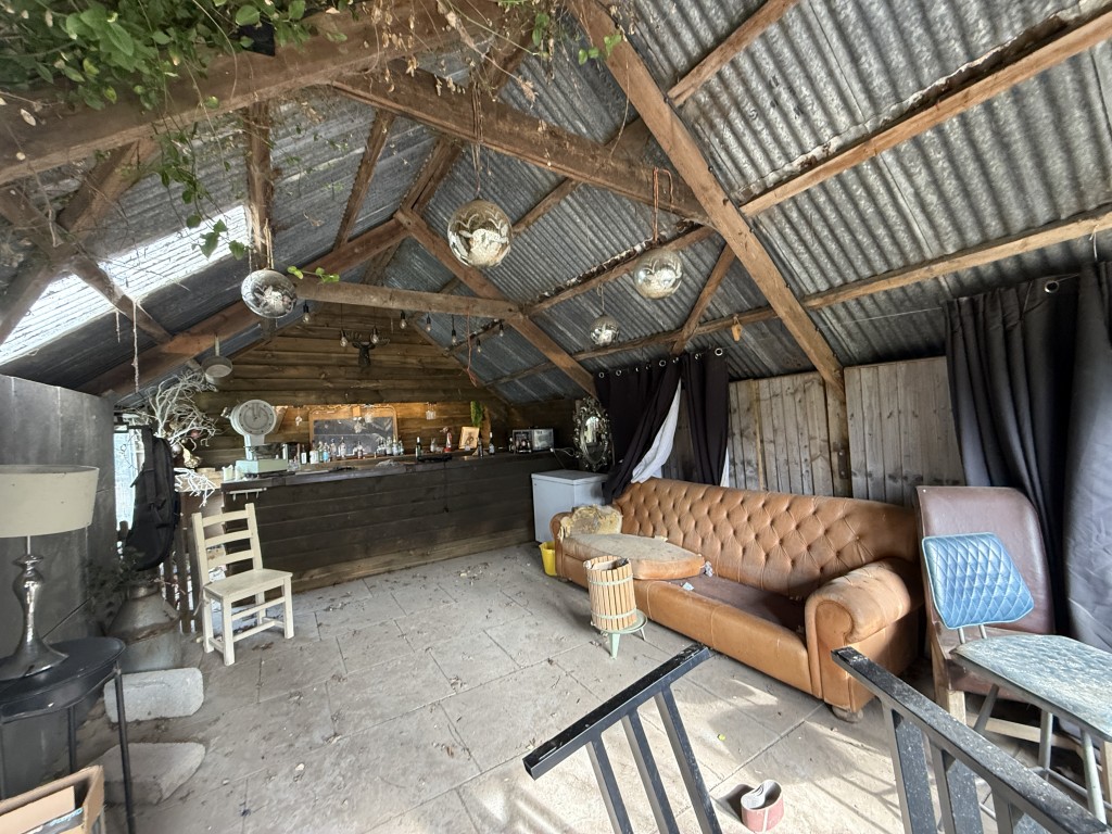 Lot: 144 - DETACHED COTTAGE WITH OUTBUILDING AND STABLES ON A SITE MEASURING OVER SIX ACRES - Interior of the double garage used as bar